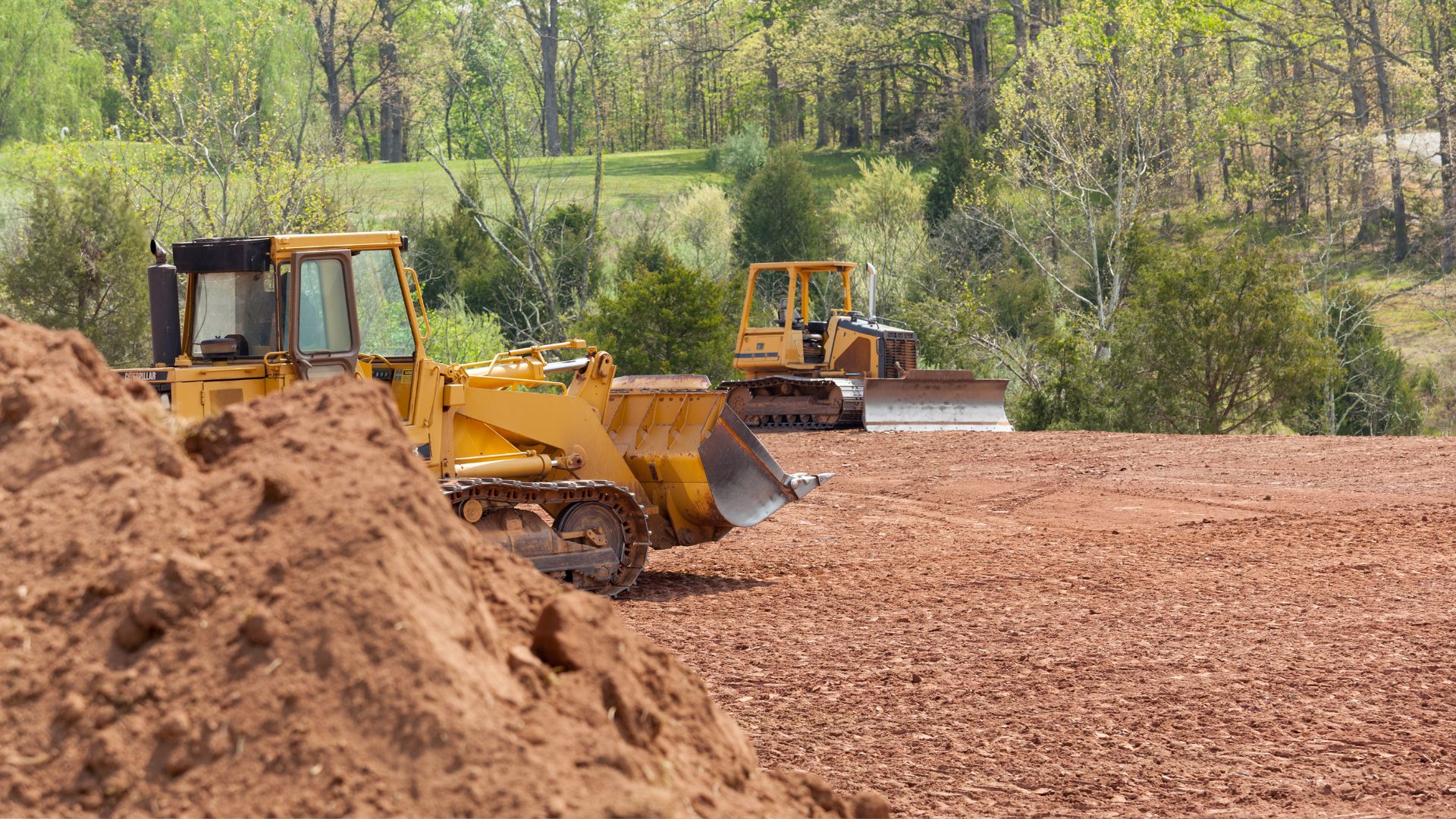 A bulldozer and a bulldozer on a dirt field