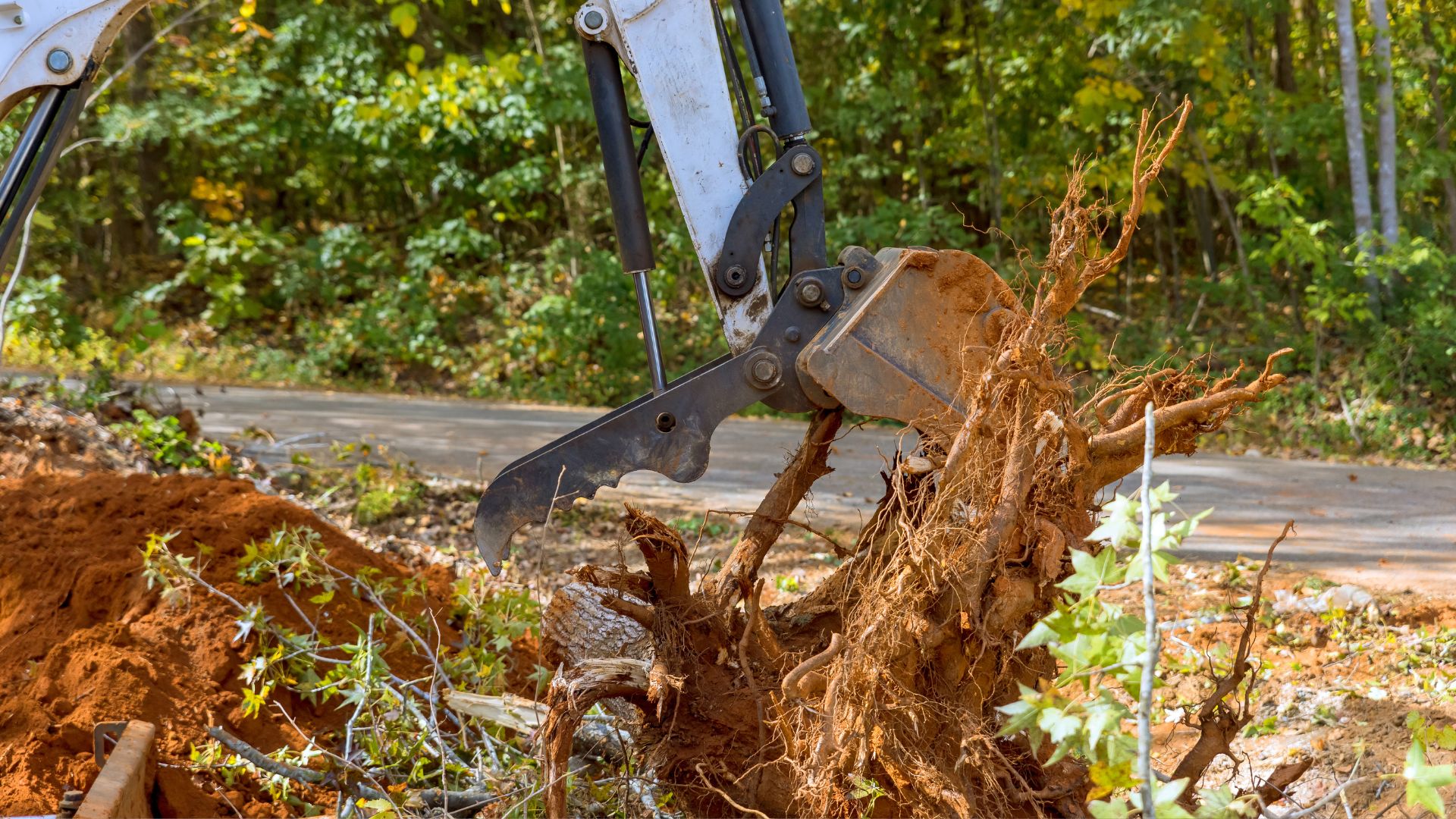 A bulldozer digging through a pile of dirt